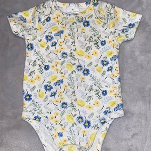 Cute baby girl onesie with flowers .